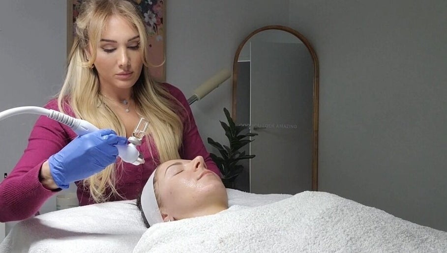 Beauty treatment at Body Glow in Melbourne, Victoria, AU. Aesthetician applying care to a client's face.