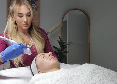 Beauty treatment at Body Glow in Melbourne, Victoria, AU. Aesthetician applying care to a client's face.