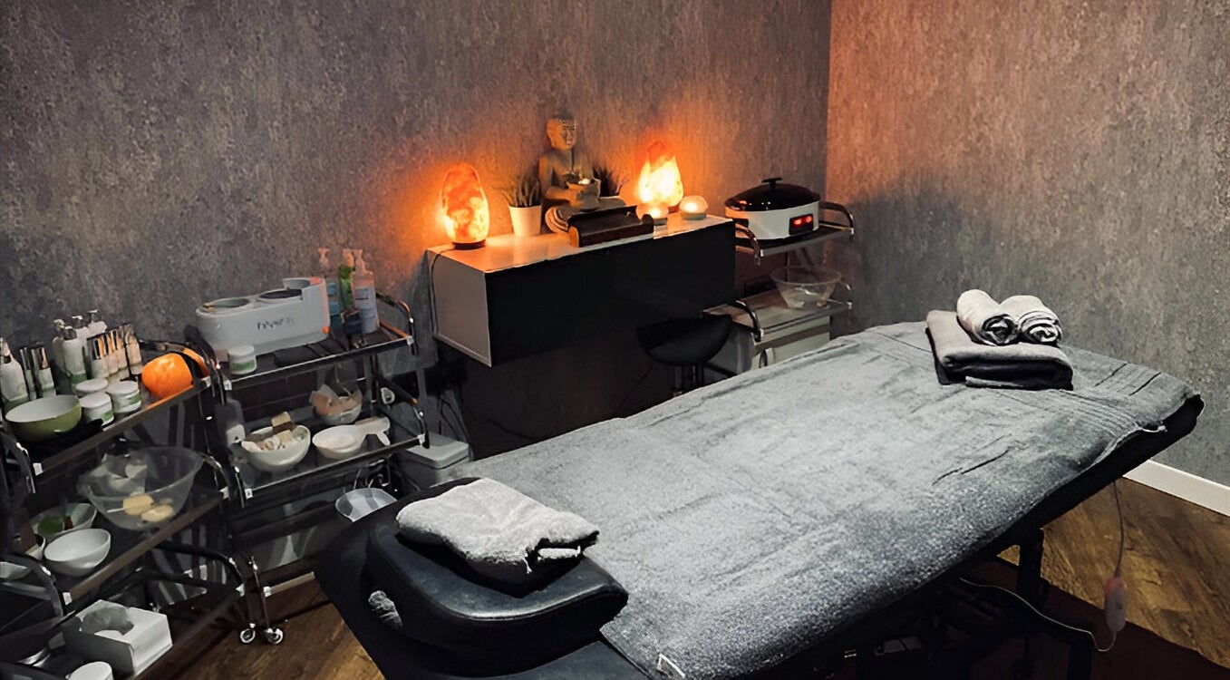 Serene massage room at Claire Wray, Ashton-under-Lyne, England, GB, with soft lighting and cozy towels.