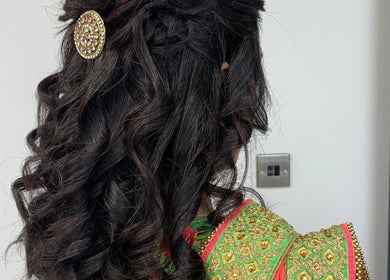 Intricate curly hairstyle adorned with ornate clip at Gayatri Beauty Clinic, Leicester, England, GB.