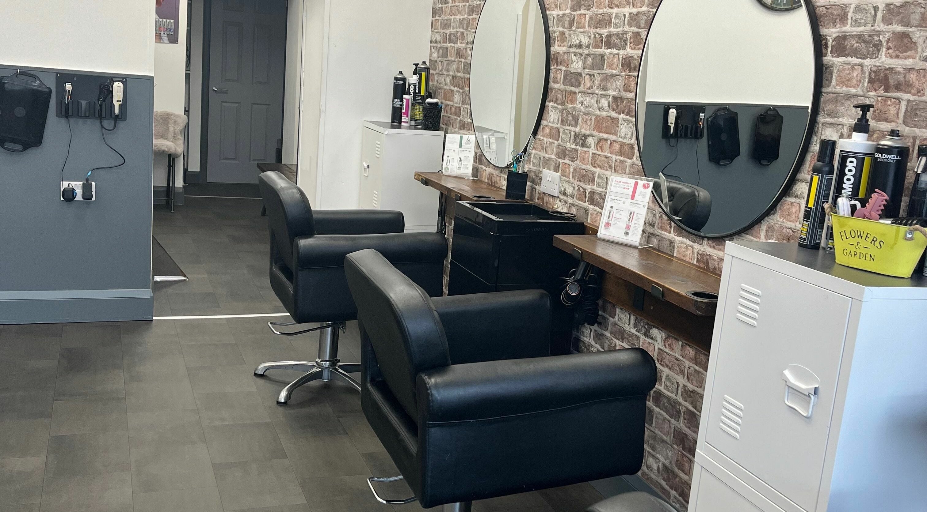Modern salon chairs and mirrors in M&D’s Hair Studio, Kilmarnock, Scotland, GB.
