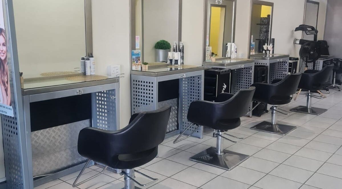 Modern salon chairs and mirrors at Jem Strandfontein, Cape Town, Western Cape, ZA offer a chic styling experience.
