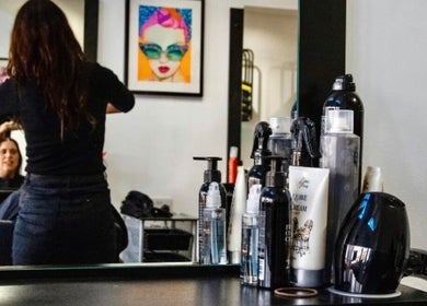 Stylist working at Zest Studio, Colchester, England, GB with hair products and decorative art.
