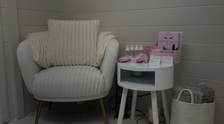Elegant cozy corner at Els Bels Beauty x Hatfield, England, GB featuring a plush chair and side table decor.