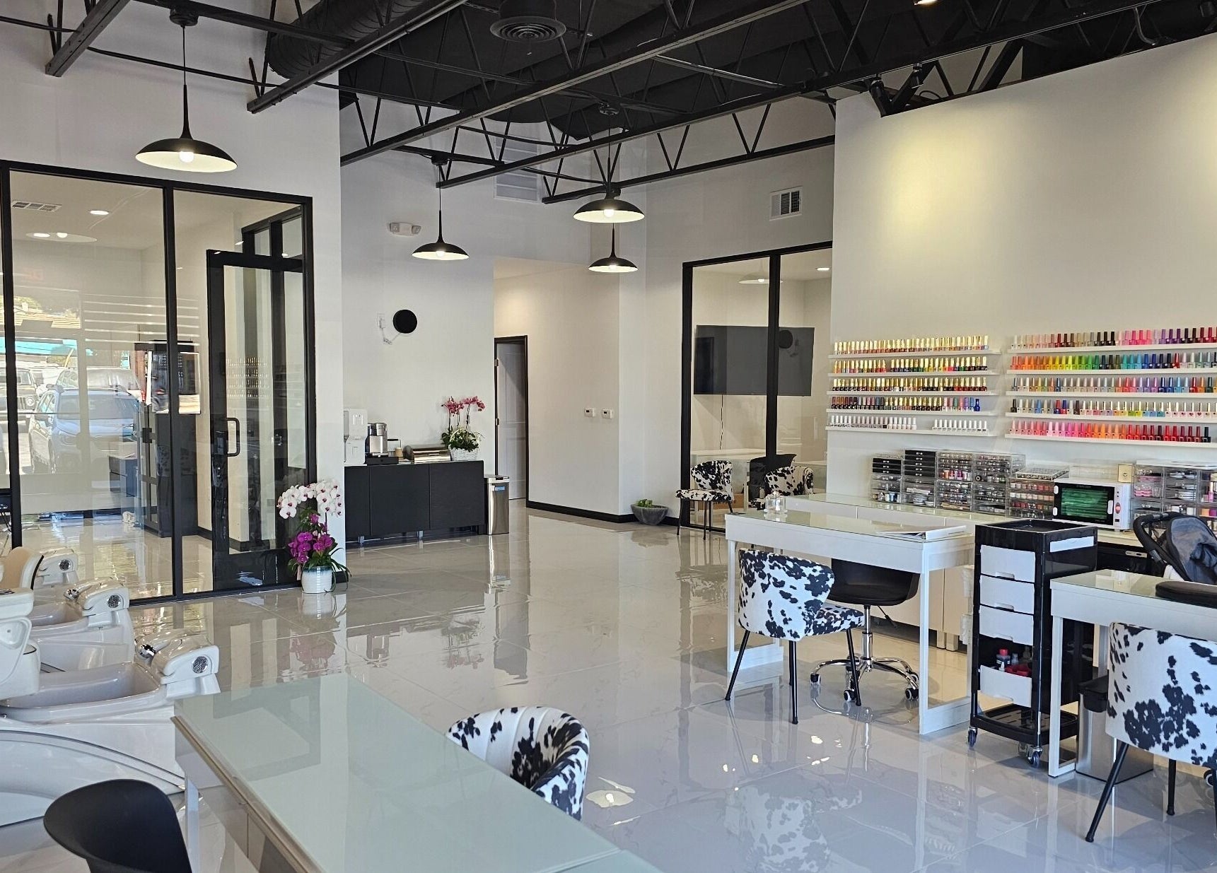 Modern salon interior at Ombré Terrace ™, Torrance, California, US, showcasing nail polish displays and styling chairs.