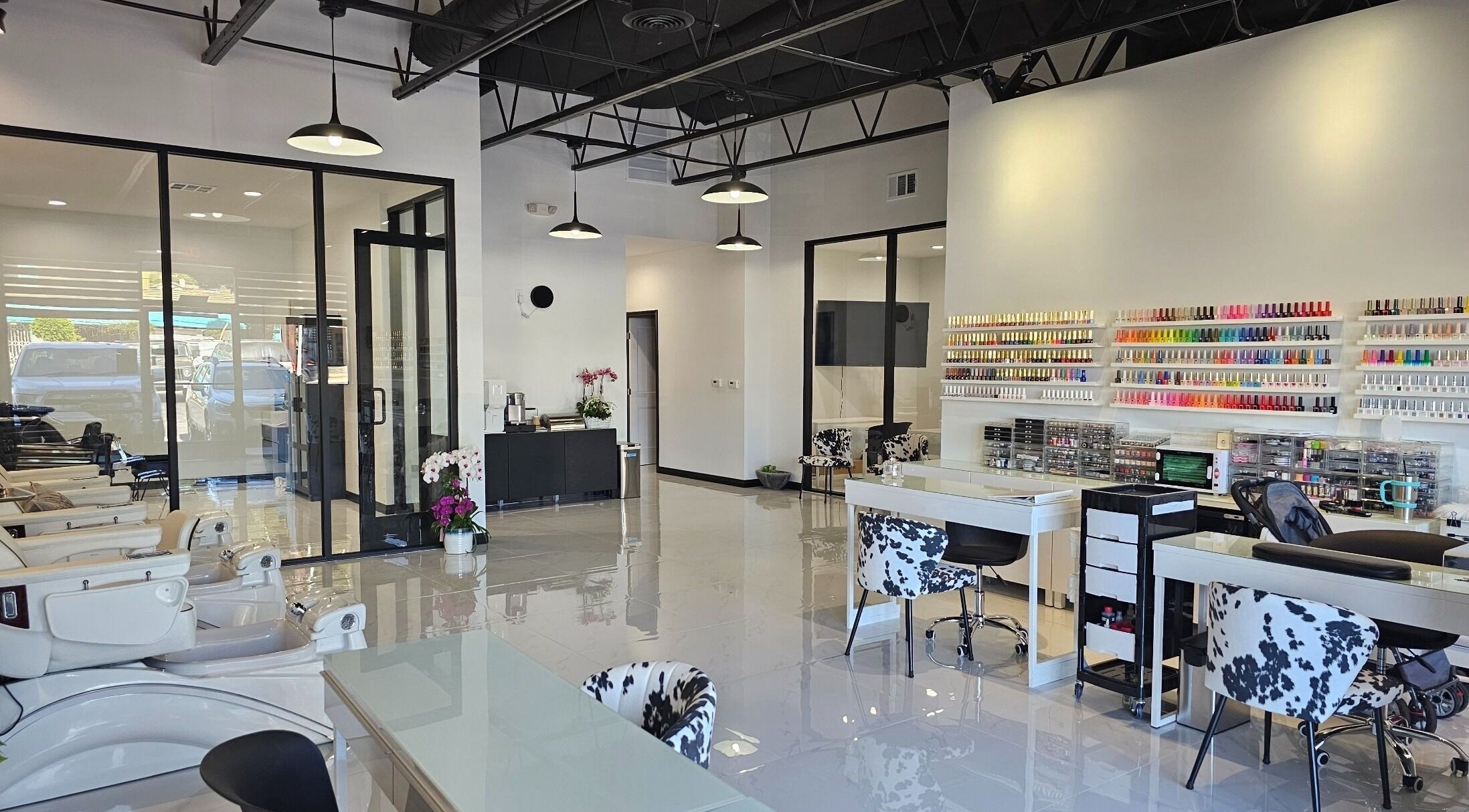 Modern salon interior at Ombré Terrace ™, Torrance, California, US, showcasing nail polish displays and styling chairs.