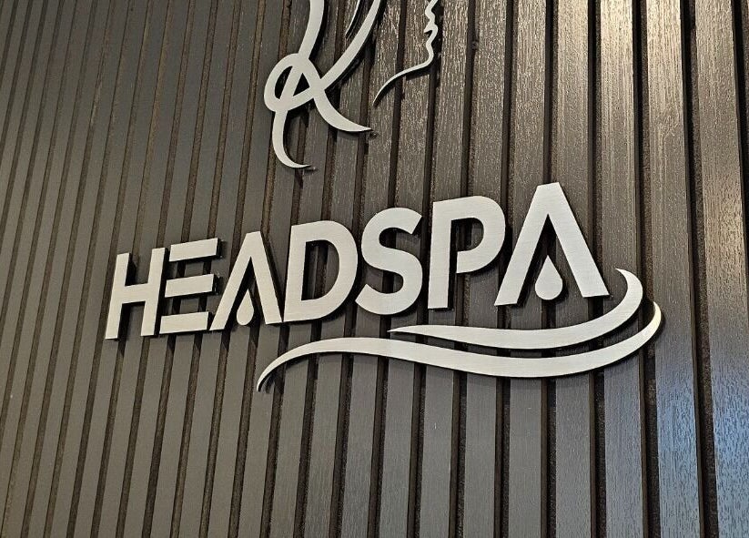 Headspa signage at Ombré Terrace ™, Torrance, California, US on sleek wooden backdrop.