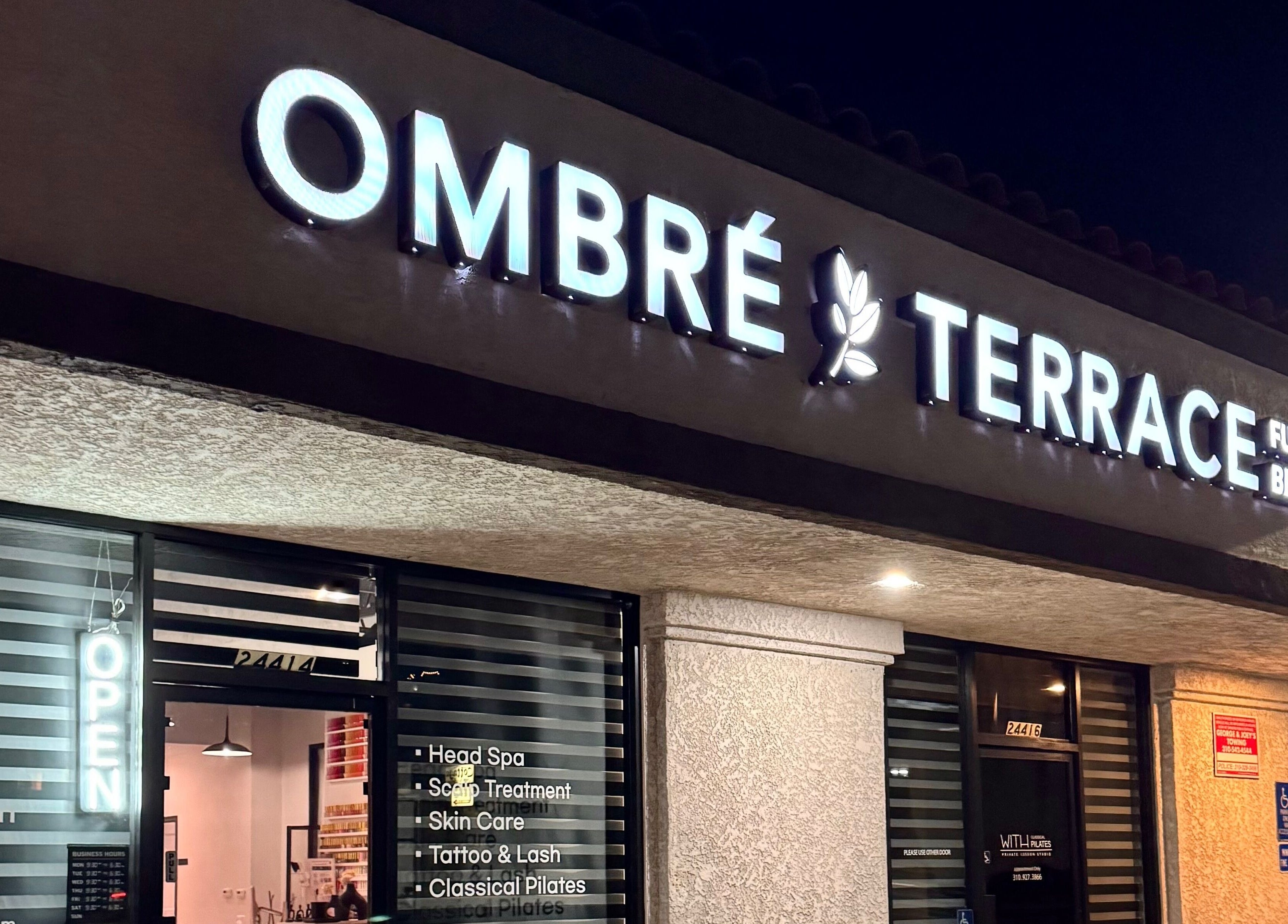 Ombré Terrace ™ entrance sign glowing at night, Torrance, California, US.