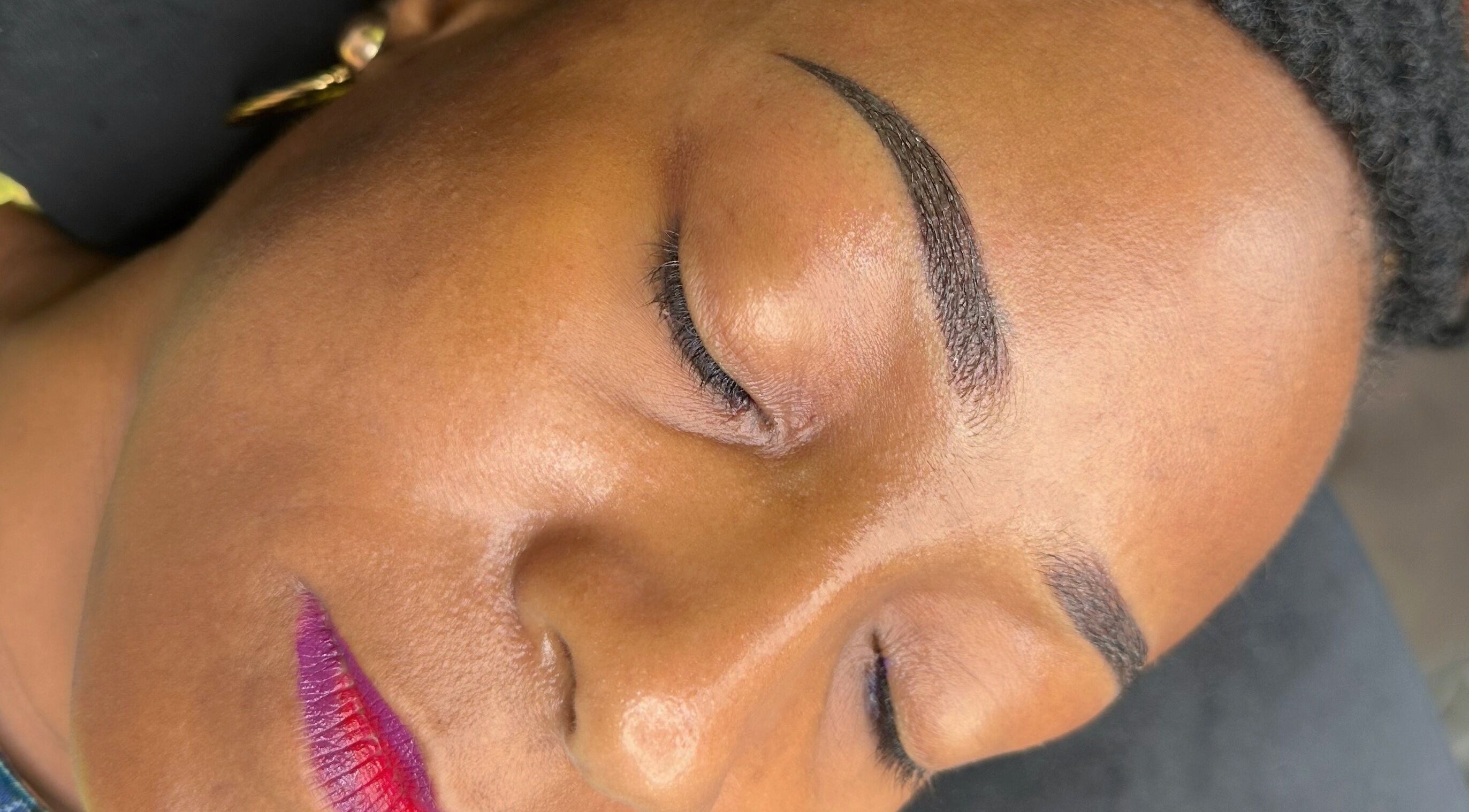 Close-up of flawless eyebrow and vibrant lips treatment at Stardust Beauté Studio, Bridgetown, Saint Michael, BB.