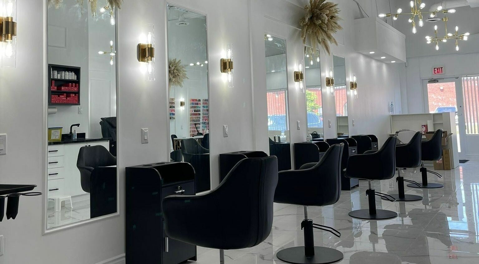 Modern salon interior at Twenty Six Beauty Bar, Mississauga, Ontario, CA with sleek black chairs and mirrors.