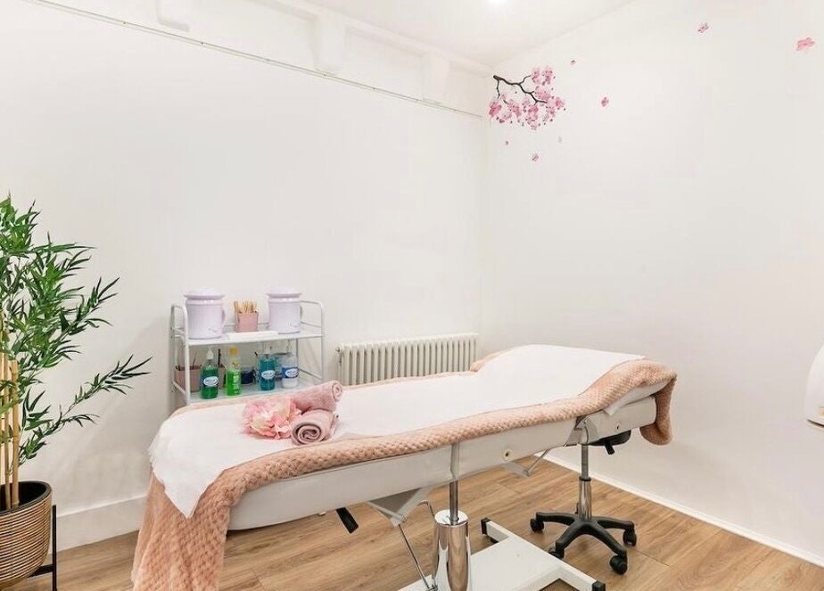 Cozy treatment room at Arta Beauty Clinic in London, England, GB, featuring a massage bed and elegant decor.