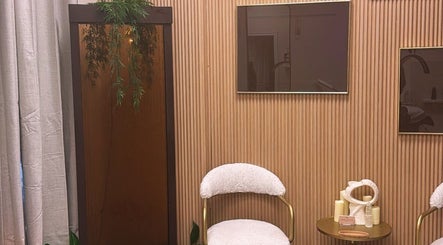 Modern, relaxing waiting area at NEWWAY Aesthetics, London, Ontario, CA with plush chairs and calming decor.