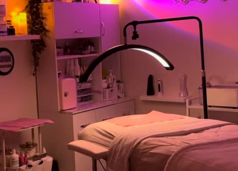 Cozy treatment room at NEWWAY Aesthetics in London, Ontario, CA with soft ambient lighting and beauty equipment.