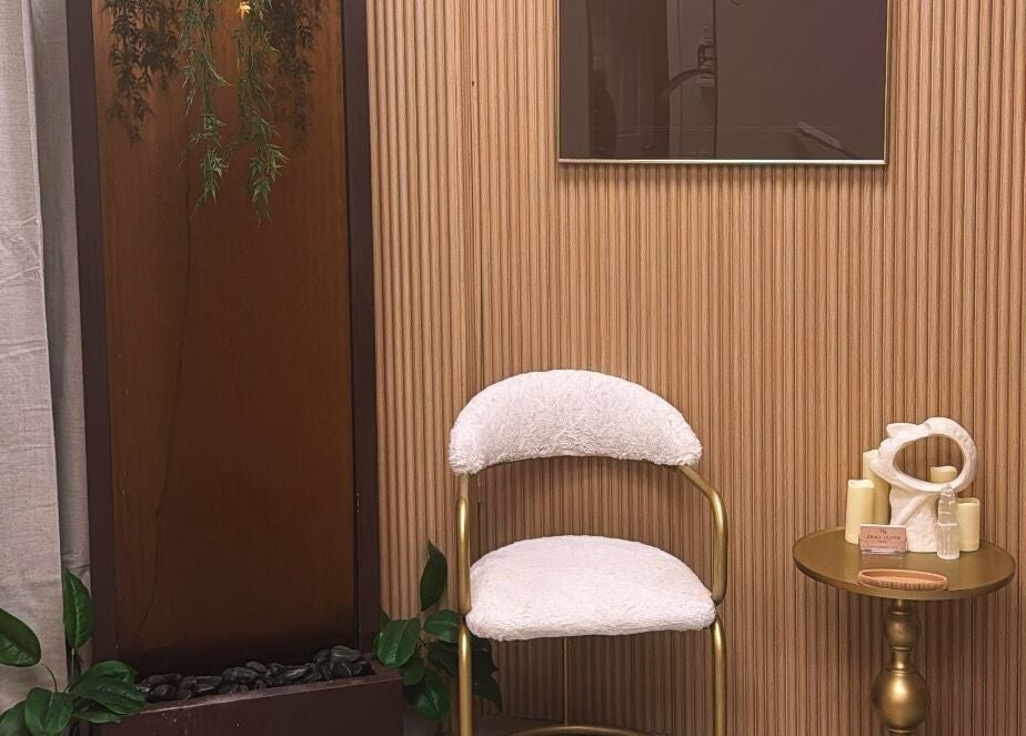 Cozy seating area at NEWWAY Aesthetics, London, Ontario, CA with elegant decor and plush chairs.