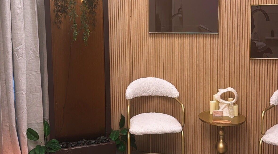 Cozy seating area at NEWWAY Aesthetics, London, Ontario, CA with elegant decor and plush chairs.