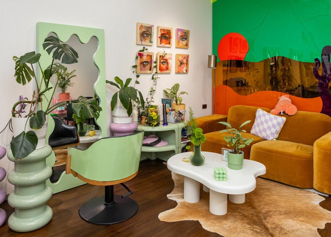 Vibrant interior at Dollie and Stella, Sydney, Australia, AU. Cozy seating with green and orange decor.