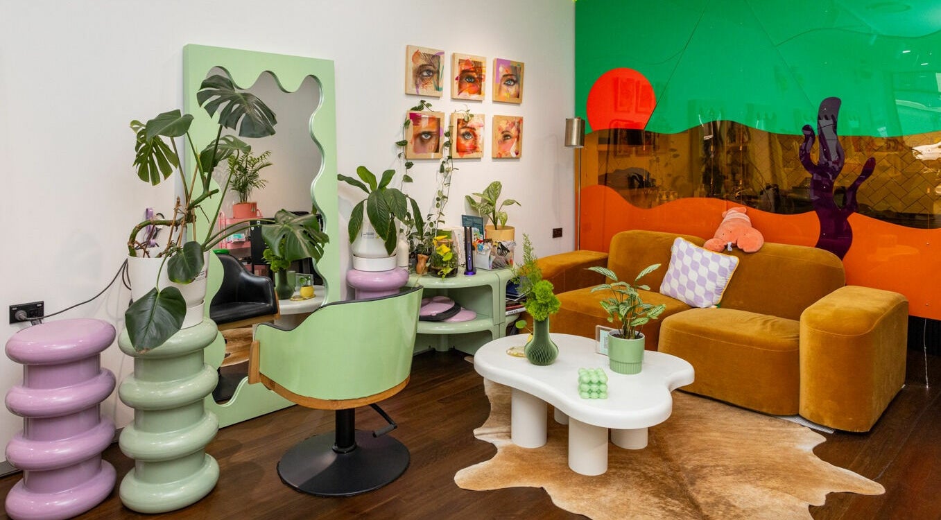 Vibrant interior at Dollie and Stella, Sydney, Australia, AU. Cozy seating with green and orange decor.