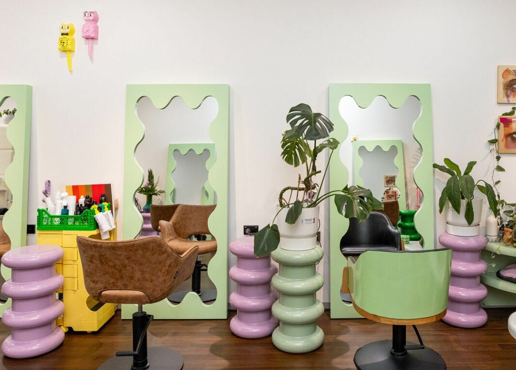 Colorful salon interior with wavy mirrors and plants at Dollie and Stella, Sydney, Australia, AU.