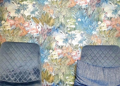 Stylish seating at Precision Therapy at Hairmonious Emsworth, Emsworth, England, GB with tropical flamingo wallpaper.