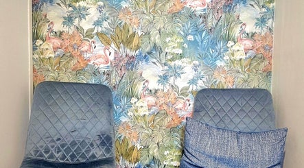 Stylish seating at Precision Therapy at Hairmonious Emsworth, Emsworth, England, GB with tropical flamingo wallpaper.