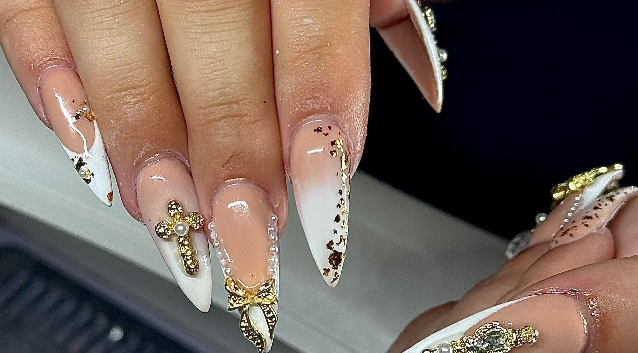 Elegant nail art with gold accents at HS Beauty, Southampton, England, GB.