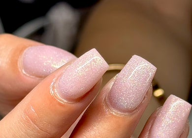 Close-up of glittering pink nails at HS Beauty, Southampton, England, GB for a dazzling manicure.