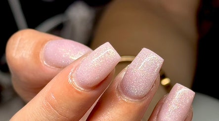 Close-up of glittering pink nails at HS Beauty, Southampton, England, GB for a dazzling manicure.