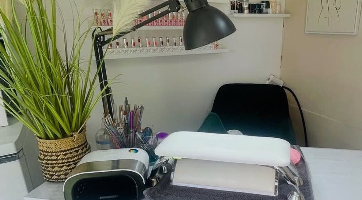 Cozy nail station at Ashley Michelle, Widnes, England, GB with modern decor and vibrant greenery.