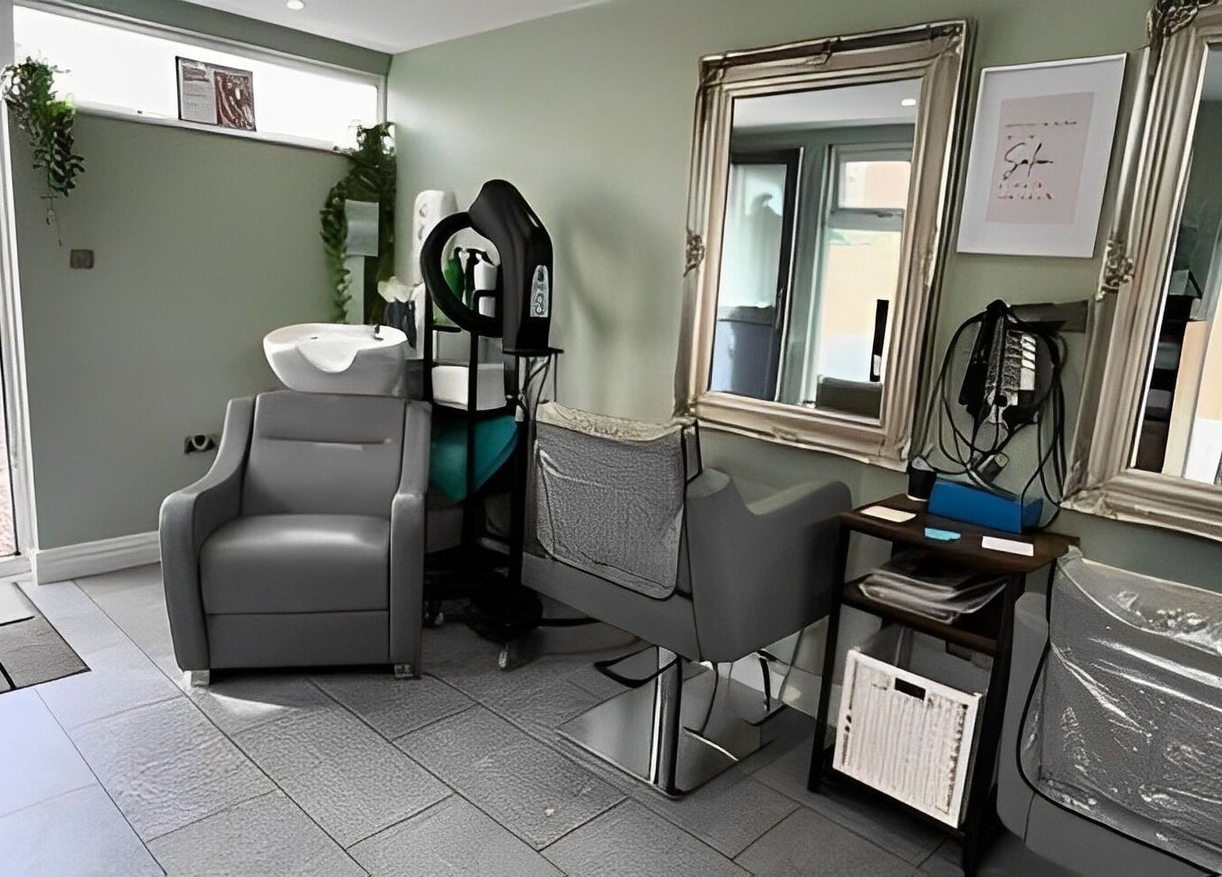 Modern salon station at Reflections by Cheryl in Stafford, England, GB featuring elegant mirrors and styling chairs.