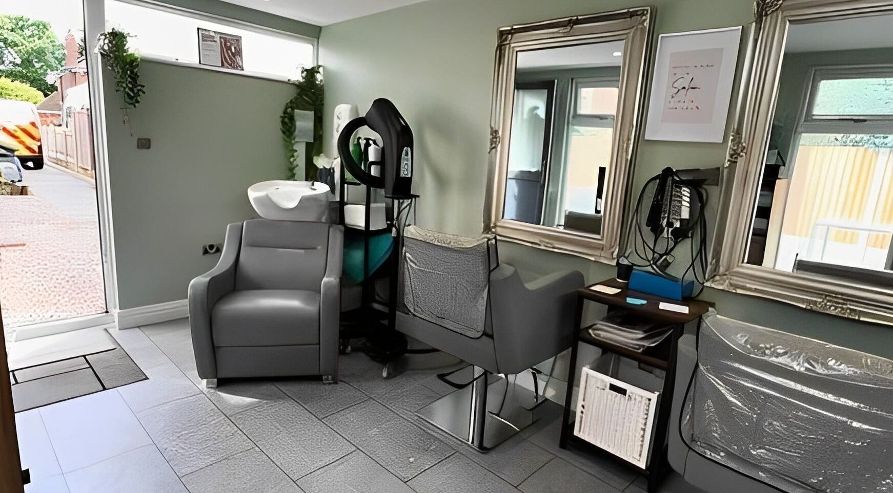 Modern salon station at Reflections by Cheryl in Stafford, England, GB featuring elegant mirrors and styling chairs.