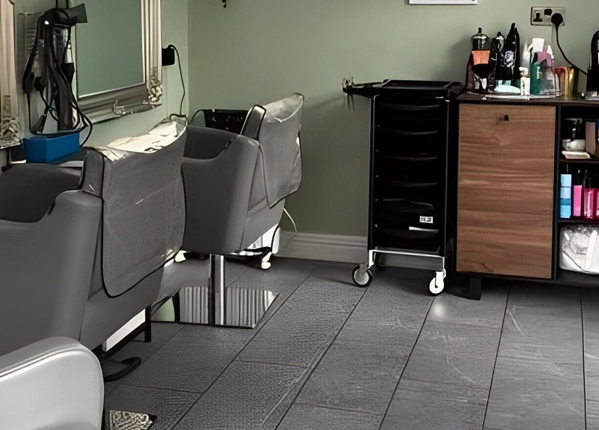 Interior of Reflections by Cheryl, Stafford, England, GB, featuring modern salon chairs and sleek styling stations.