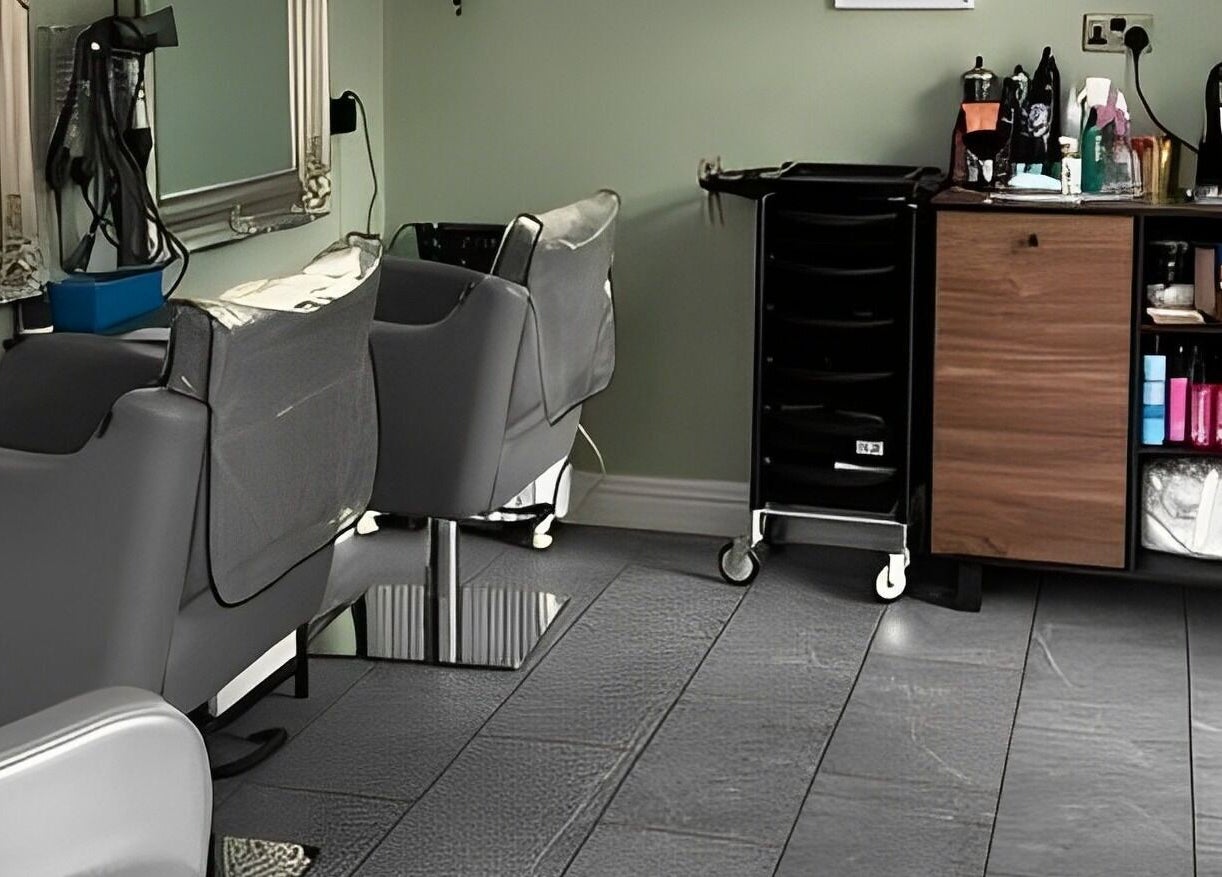 Interior of Reflections by Cheryl, Stafford, England, GB, featuring modern salon chairs and sleek styling stations.