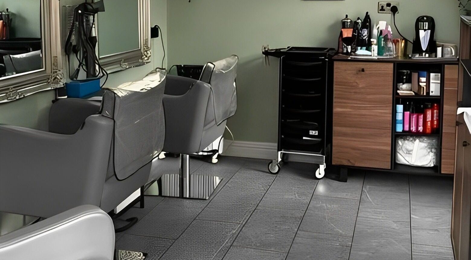 Interior of Reflections by Cheryl, Stafford, England, GB, featuring modern salon chairs and sleek styling stations.
