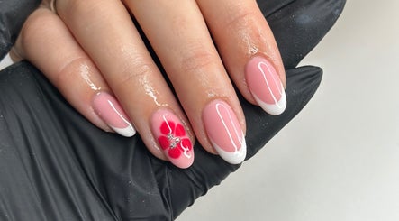 Beautiful floral nail design at Livin Beauty Lounge, Purton, England, GB. Pink and white manicure with red flower.