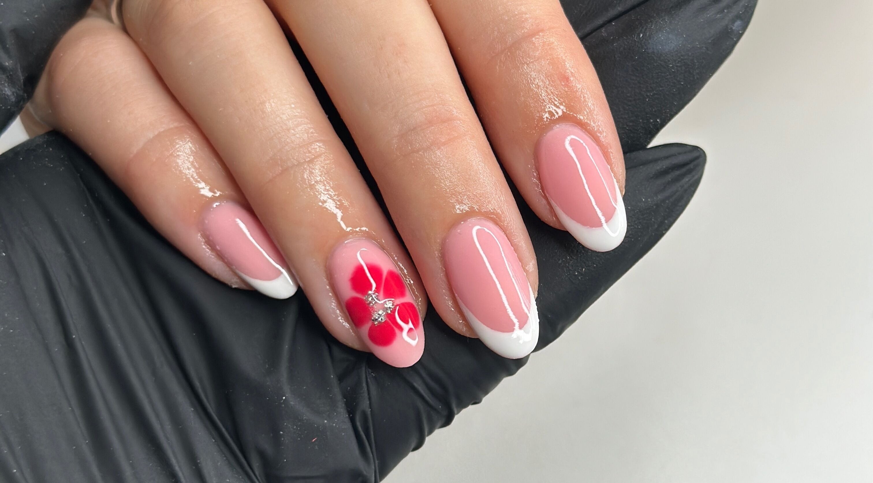 Beautiful floral nail design at Livin Beauty Lounge, Purton, England, GB. Pink and white manicure with red flower.