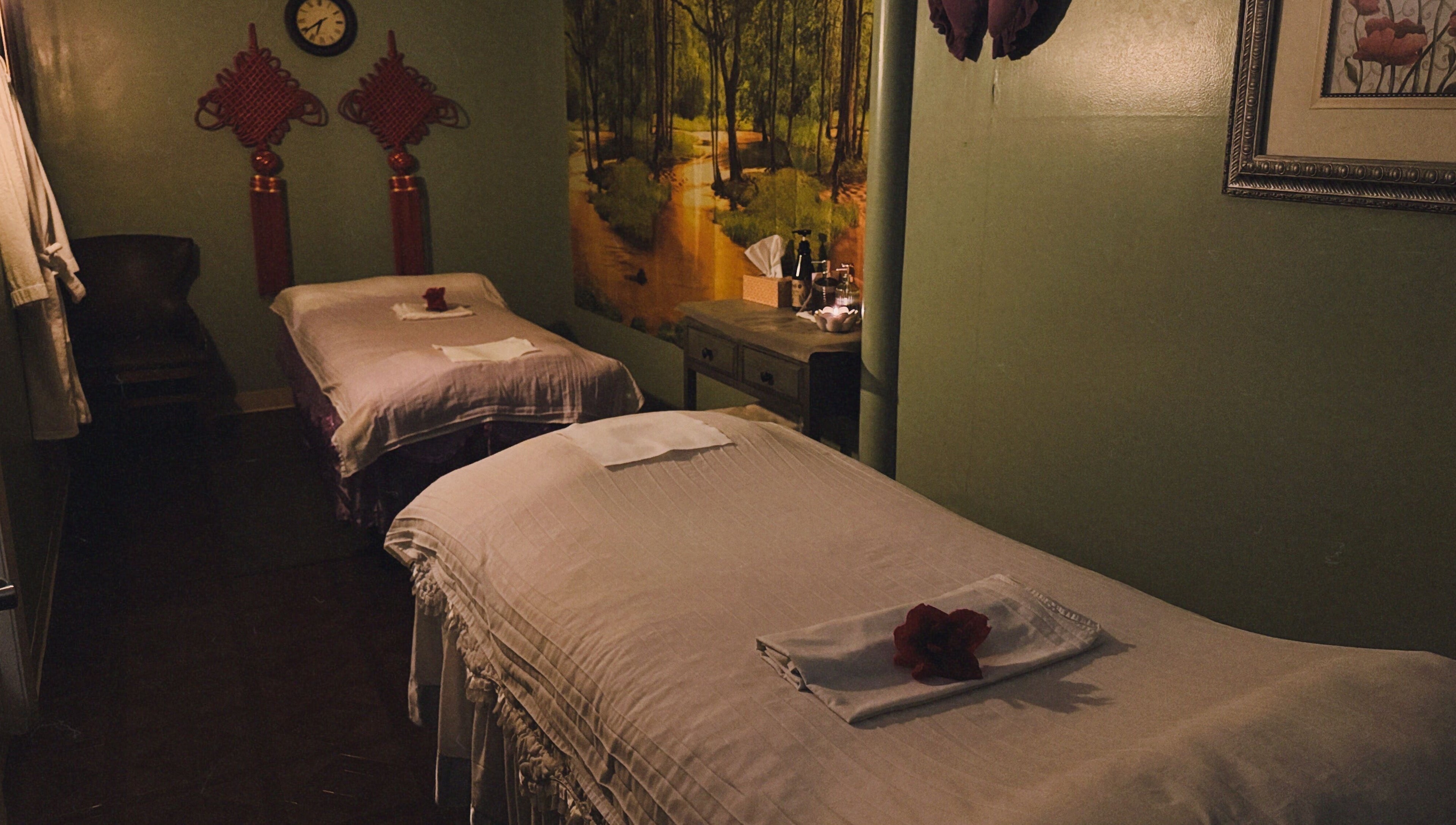 Relaxing massage room at Asian Massage in Chesapeake, Virginia, US with two beds and warm decor.