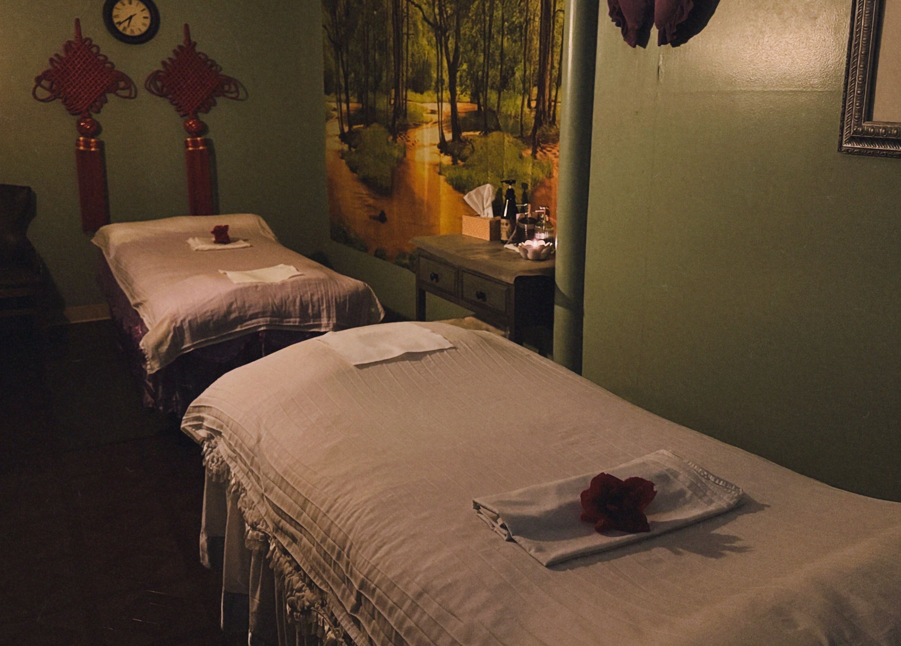 Relaxing massage room at Asian Massage in Chesapeake, Virginia, US with two beds and warm decor.