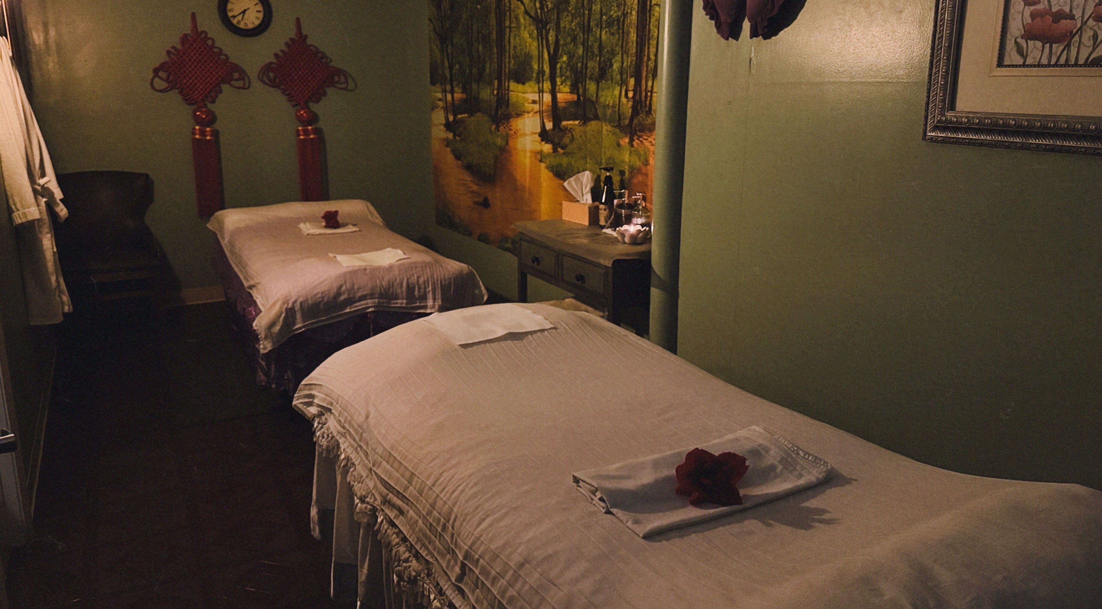 Relaxing massage room at Asian Massage in Chesapeake, Virginia, US with two beds and warm decor.