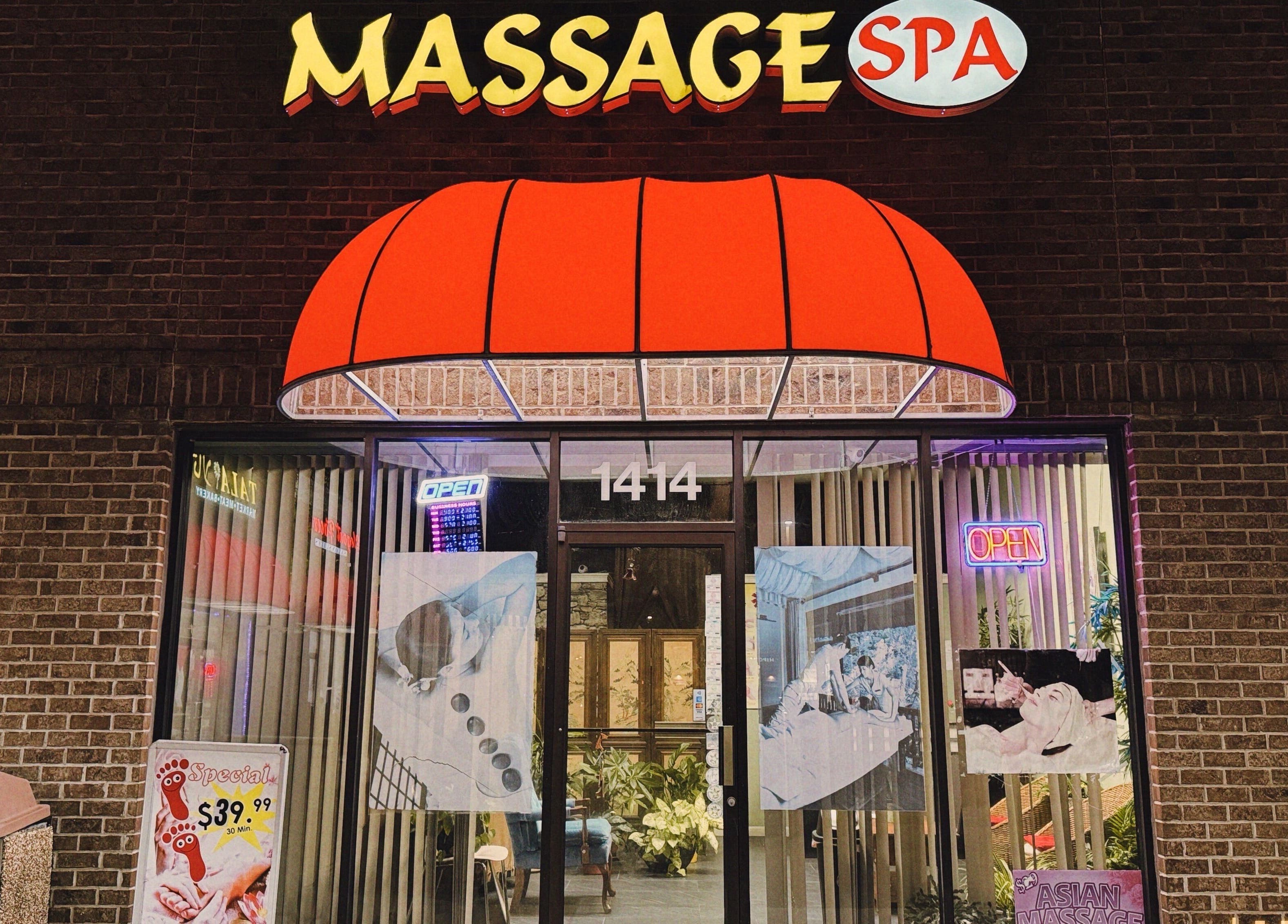 Front view of Asian Massage in Chesapeake, Virginia, US, with a bright red awning and glowing signage.
