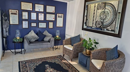 Elegant waiting area with cozy seating at Sharons Massage Studio, Mossel Bay, Western Cape, ZA.