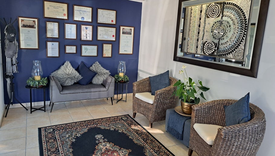 Elegant seating area at Sharons Massage Studio, Mossel Bay, Western Cape, ZA, with plush decor and framed diplomas.