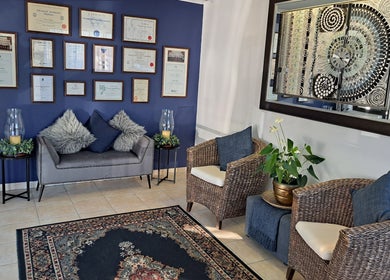 Elegant seating area at Sharons Massage Studio, Mossel Bay, Western Cape, ZA, with plush decor and framed diplomas.
