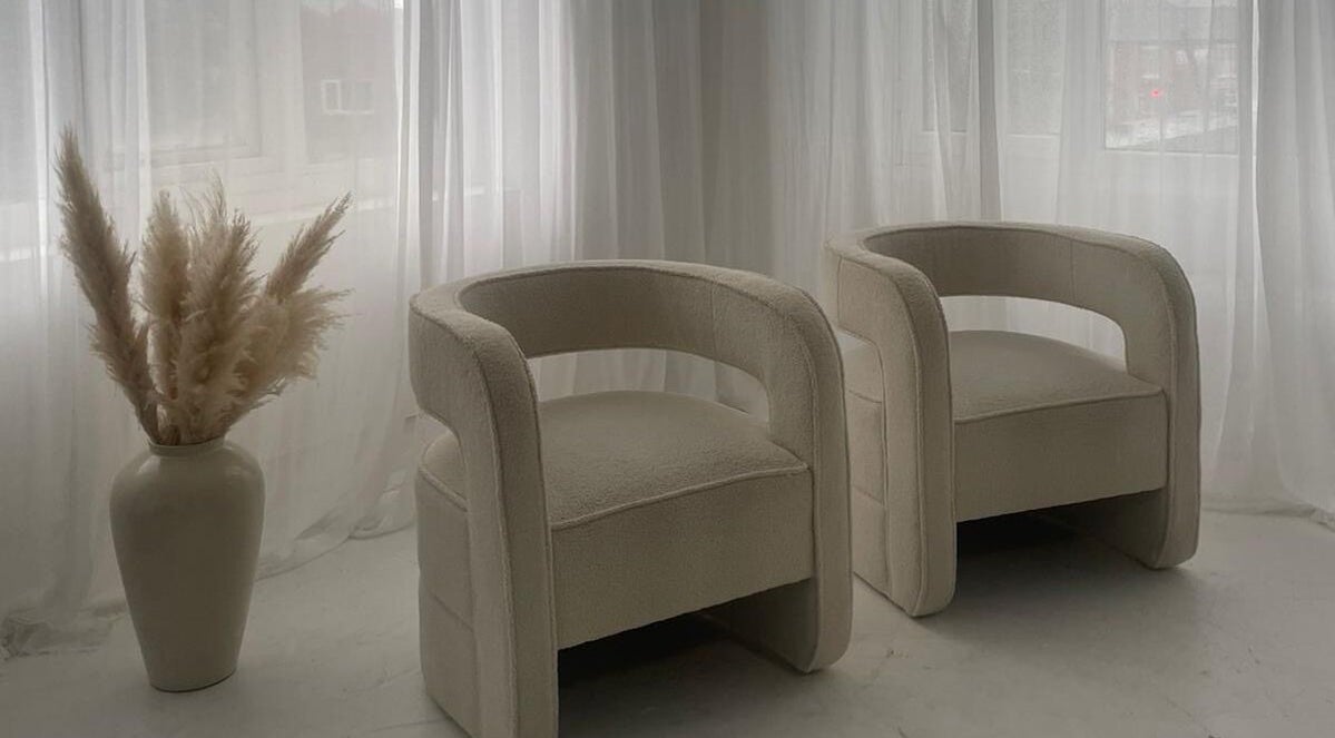 Modern cream chairs and pampas in serene setting at Tanned Professional, Bury, England, GB.