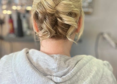 Stylish updo created at Adele Howarth Hair, Glasgow, Scotland, GB salon, showcasing expert styling.