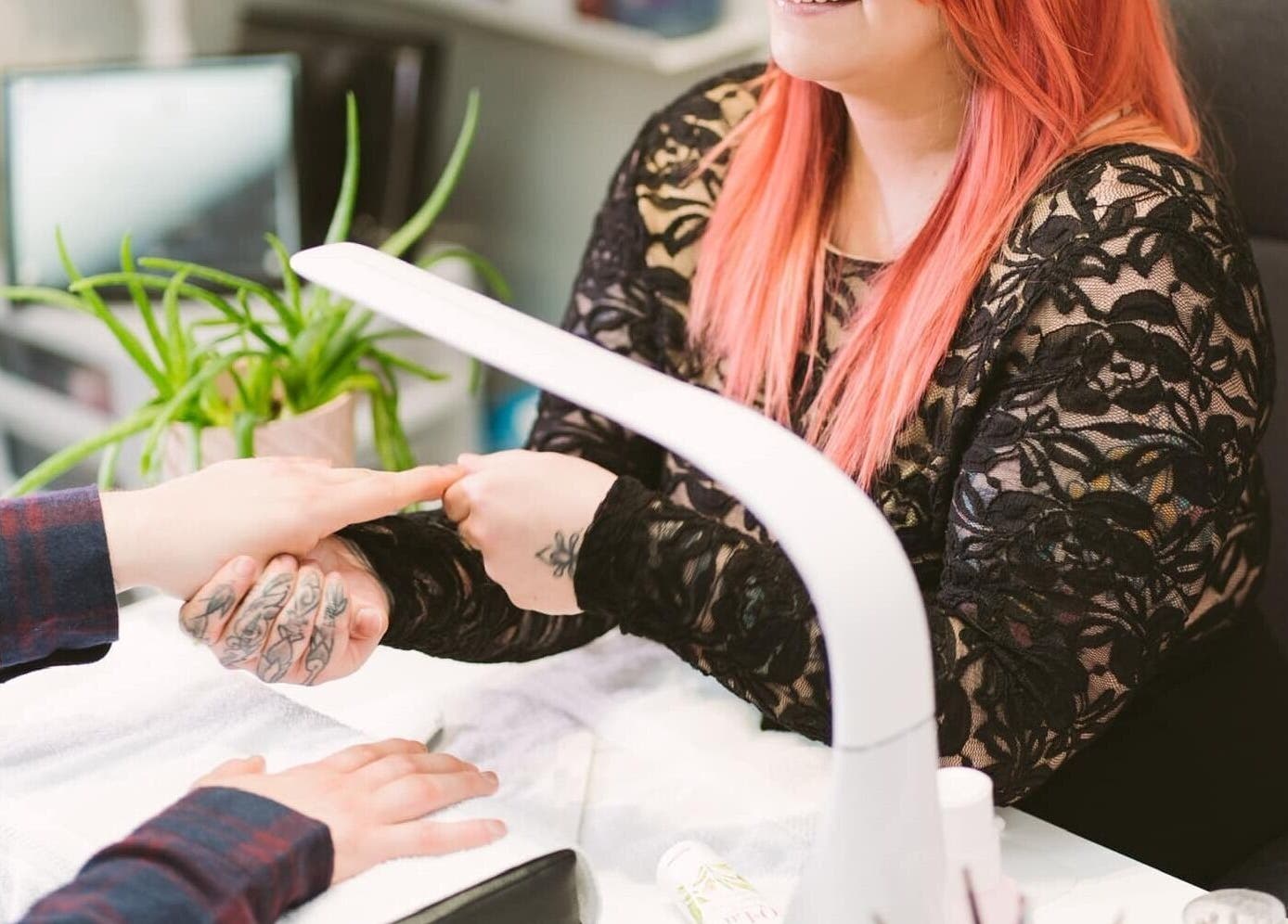 Nail technician at Polished Studio in Torbay, NL, CA providing a manicure service.