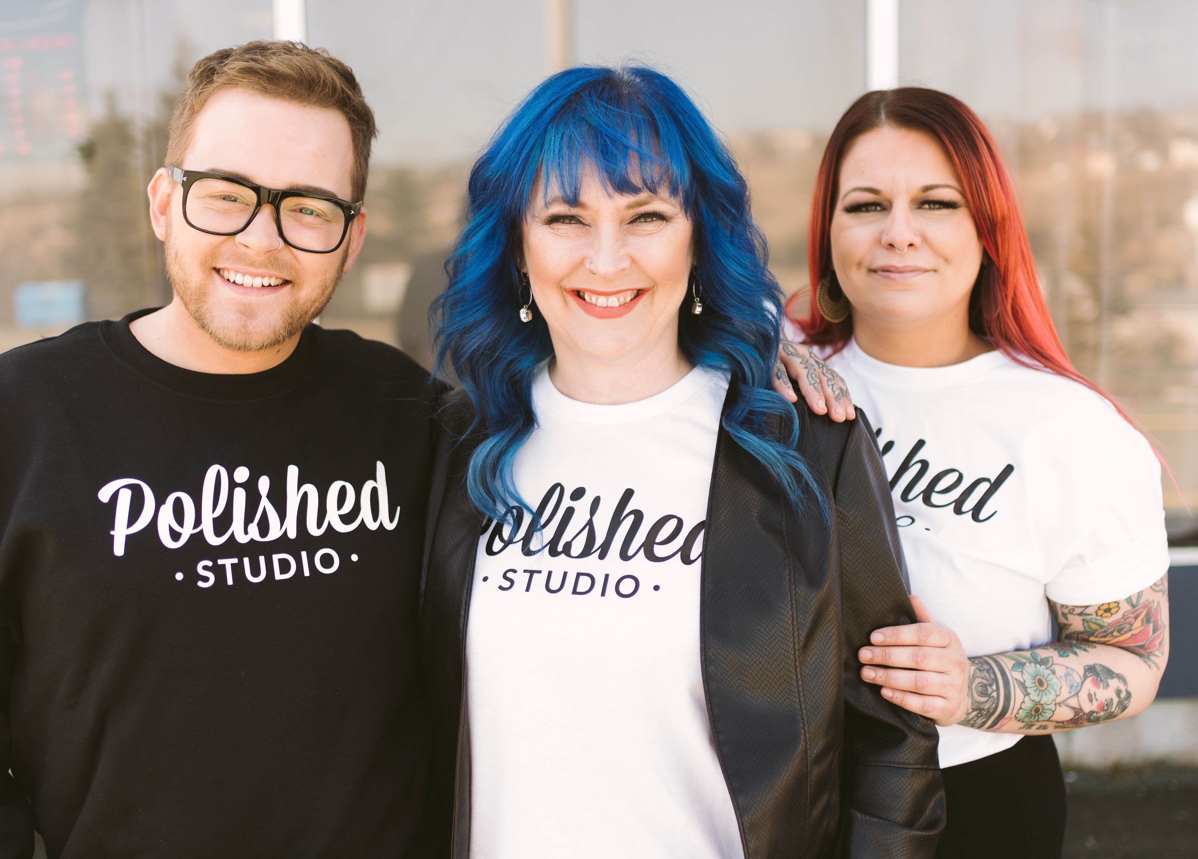 Team members at Polished Studio, Torbay, NL, CA, smiling in branded attires.