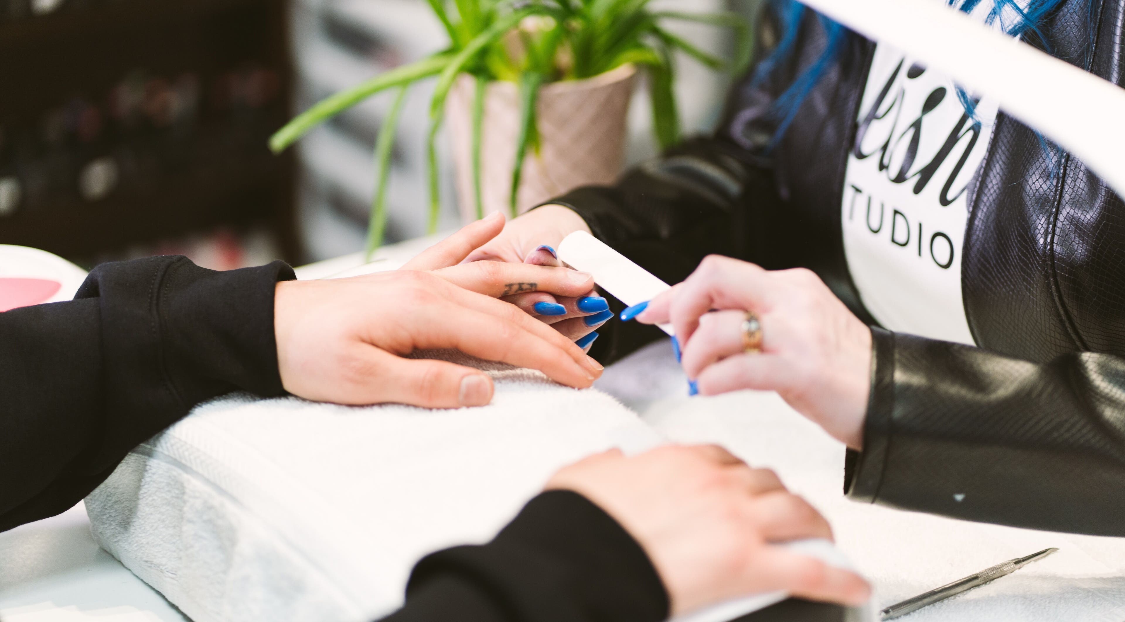 Nail artist at Polished Studio (Kim McGrath) shaping nails in Torbay, NL, CA.