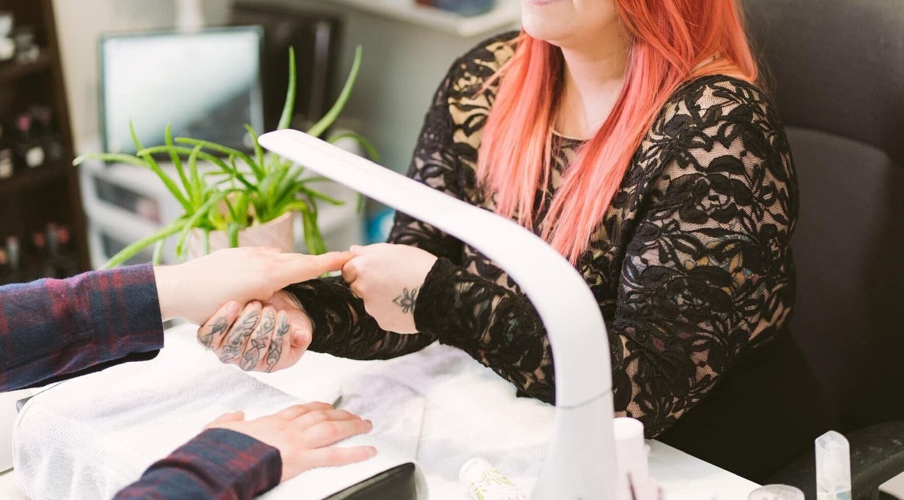 Skilled nail technician at Polished Studio (Kim McGrath) in Torbay, NL, CA performing a manicure.