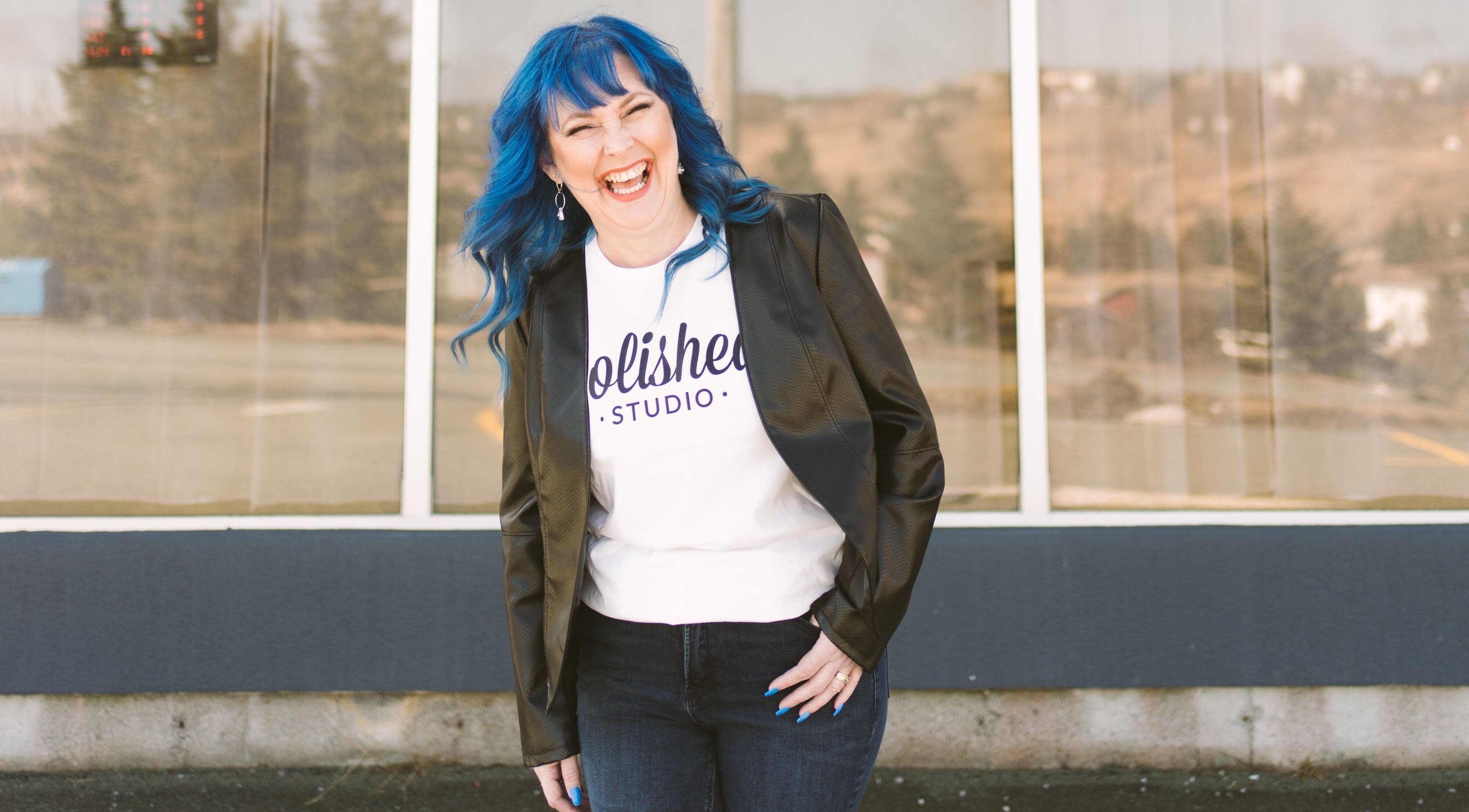 Person in Polished Studio attire smiles brightly outside Polished Studio, Torbay, NL, CA.