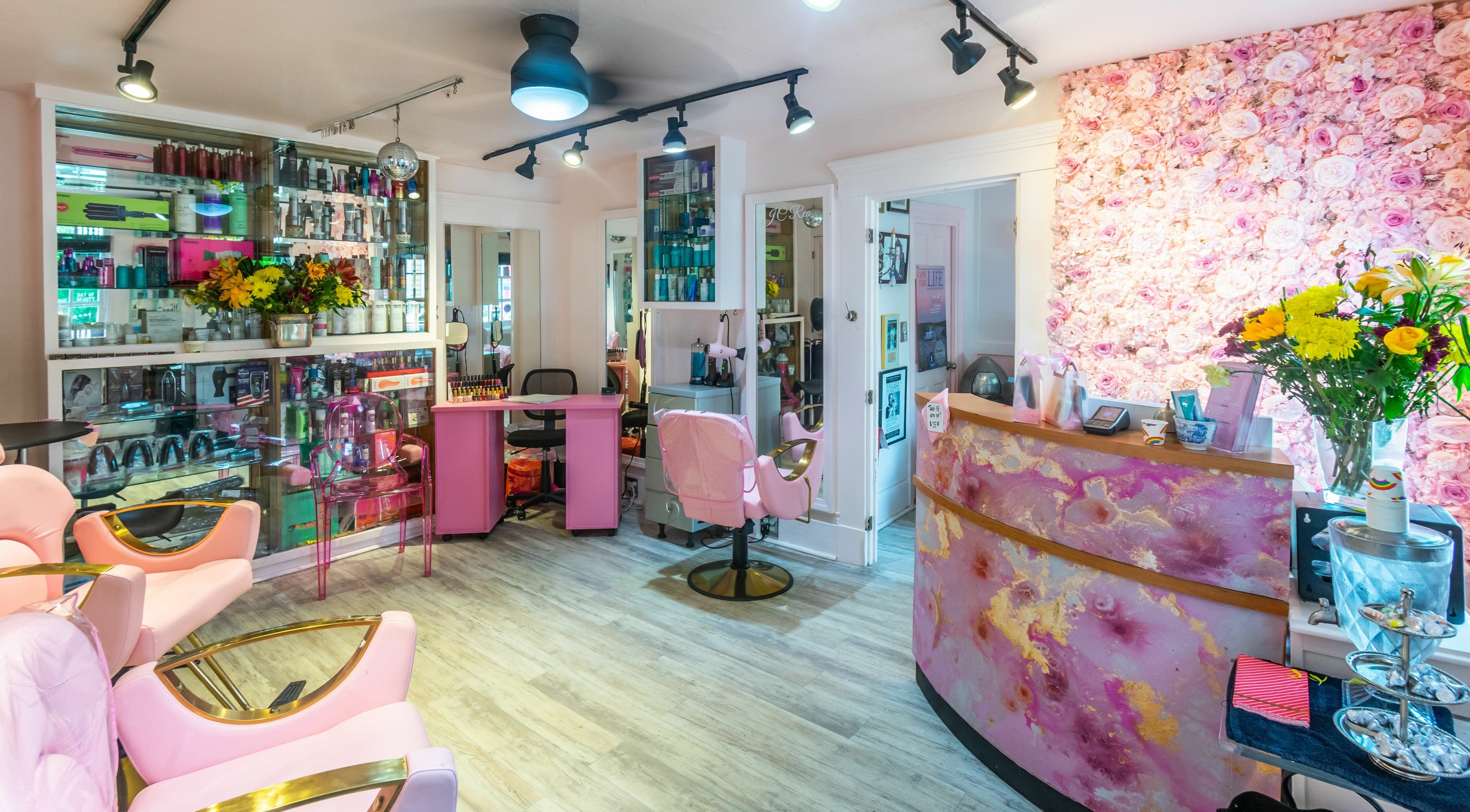 Vibrant interior at West End Salon & Spa in Provincetown, Massachusetts, US, featuring pink decor and floral accents.